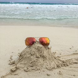 Sunglasses on sand at beach