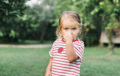 Close-up of cute girl standing at park