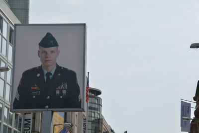 Portrait of young man standing against sky