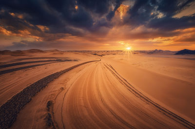 Panoramic view of desert against sky during sunset