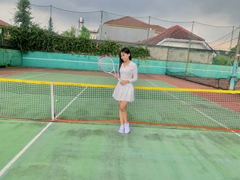 Full length of young woman standing in park