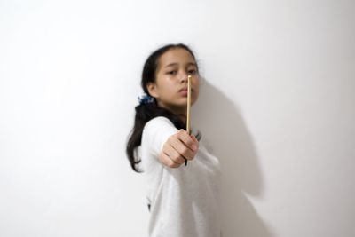 Portrait of girl standing against white background