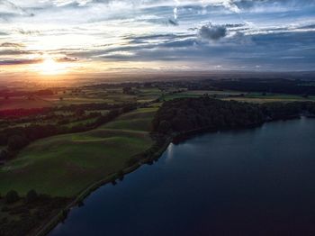 Scenic view of river against sky during sunset