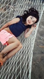 Directly above portrait of girl relaxing on hammock
