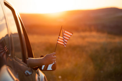 Low angle view of american flag against sky