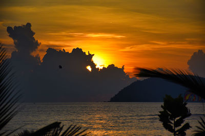 Scenic view of sea against orange sky