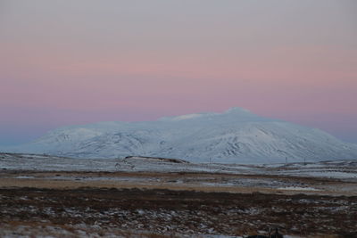 Scenic view of snowcapped mountains against sky during sunset