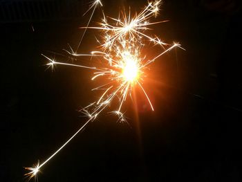 Low angle view of firework display at night