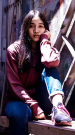 Portrait of a girl sitting outdoors