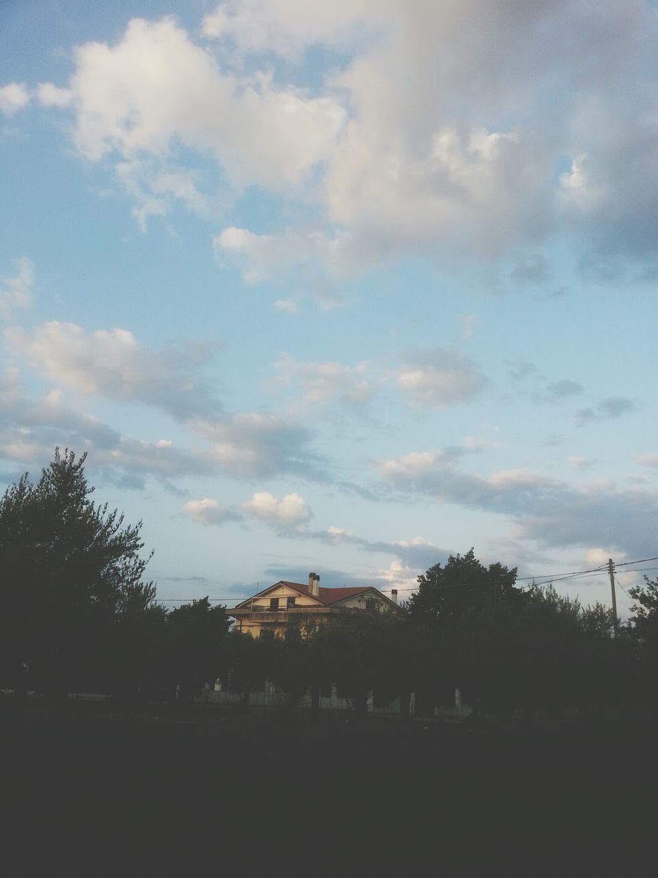 tree, sky, landscape, cloud - sky, tranquil scene, tranquility, field, scenics, silhouette, nature, beauty in nature, built structure, cloud, cloudy, architecture, building exterior, growth, house, outdoors, rural scene