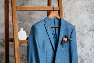 Close-up of clothes hanging on wooden wall