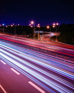 High angle view of light trails on road at night