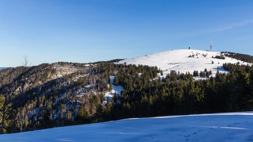 Scenic view of snowcapped mountains against blue sky