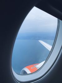 Aerial view of sea seen through airplane window
