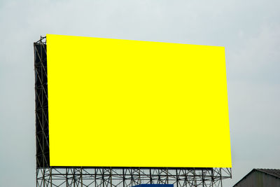 Close-up of yellow mailbox on wall