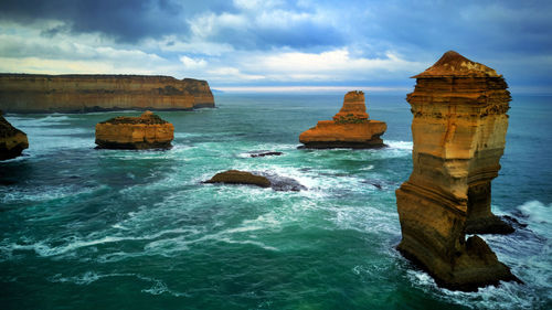 Scenic view of rocks in sea against sky