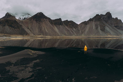 Man on black sand in desert