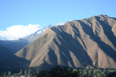 Scenic view of mountains against cloudy sky