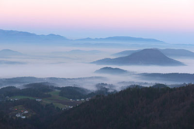 Scenic view of mountains against cloudy sky