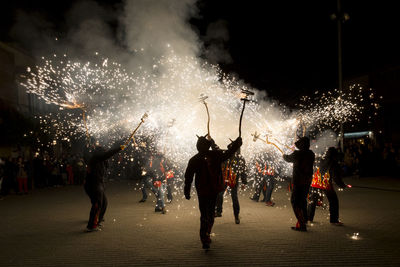 People watching firework display at night