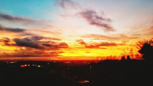 Silhouette city against sky during sunset