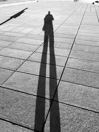 Shadow of person on footpath