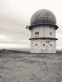 Built structure on beach against sky