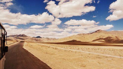 Scenic view of mountains against cloudy sky