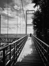 Footbridge over bridge against sky