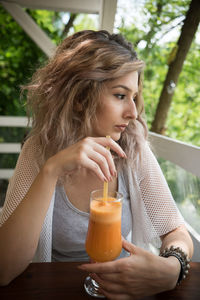 Close-up portrait of woman drinking glasses