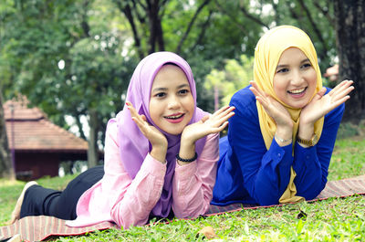 Portrait of smiling young woman sitting outdoors