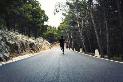 Rear view of man on road in city