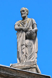 Low angle view of statue against clear blue sky