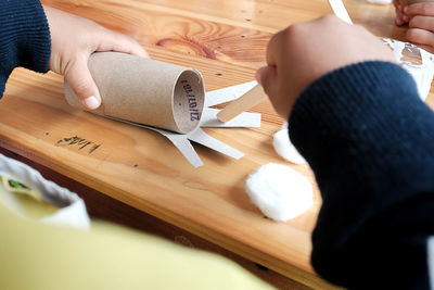 High angle view of woman hand on table