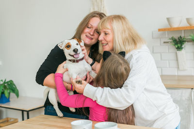 Portrait of woman with dog on table