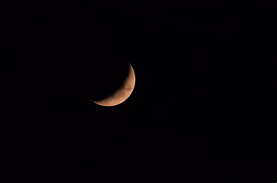 Low angle view of moon against clear sky at night