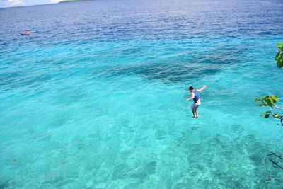 High angle view of woman swimming in sea