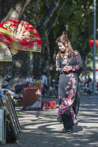 Beautiful woman browsing street market market in hue / vietnam