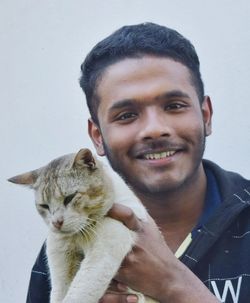 Portrait of young man and cat