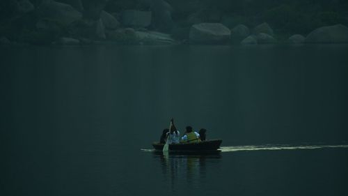 People in boat on lake