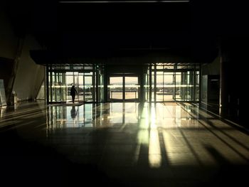 Silhouette man walking in corridor of building