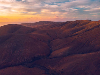 Scenic view of rocky mountains against sky during sunset