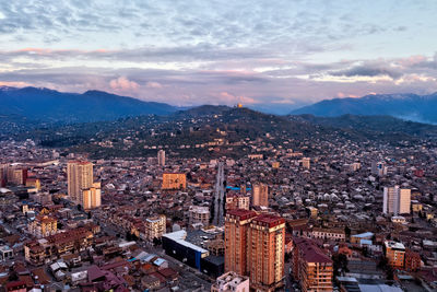 High angle view of city buildings against sky during sunset