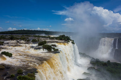 Scenic view of waterfall against sky