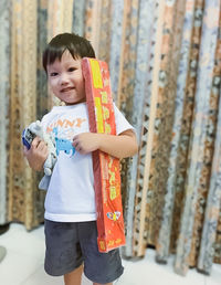 Portrait of smiling boy holding a bar of  fire cracker 