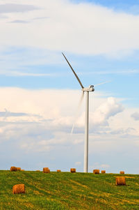 Windmill on field against sky