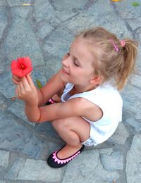 High angle view of girl sitting on floor