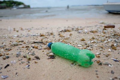 Close-up of garbage on sand