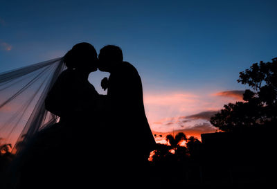 Low angle view of silhouette people against sky