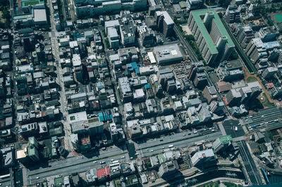 High angle view of illuminated street amidst buildings in city